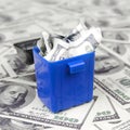 American cash notes are thrown into the trash bin on a multitude of hundred dollar bills Royalty Free Stock Photo