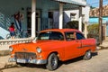 American classic car in Cuba with the national flag from Cuba