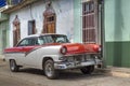 American classic car in front of a colonial house in Trinidad, Cuba