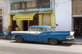 American classic car in front of a local CafÃÂ¨, Havana, Cuba