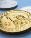 American coin lies on blue surface. One dollar coin close up. Statue of Liberty. USA economy and money. Vertical stories about Royalty Free Stock Photo