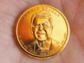 American coin lies on the palm. 1 dollar close up. Obverse coins featuring President Reagan. News about national currency, state Royalty Free Stock Photo