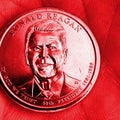 The American coin lies in the palm. 1 dollar coin with the portrait of President Ronald Reagan. Close-up. Square illustration is Royalty Free Stock Photo