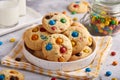 American cookies with colorful chocolate candy drops served with glass of milk.