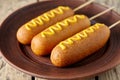 American corn dog street junk food deep fried hotdog meat sausage snack with mustard Royalty Free Stock Photo