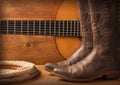 American Country music with guitar and cowboy shoes on wood text Royalty Free Stock Photo