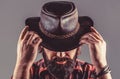 American cowboy. Leather Cowboy Hat. Portrait of young man wearing cowboy hat. Cowboys in hat. Handsome bearded macho Royalty Free Stock Photo