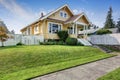 American craftsman home with yellow exterior paint.