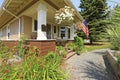 American craftsman house exterior. Cozy covered porch with white columns. Royalty Free Stock Photo