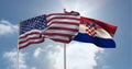 American and crotian flag waving against clouds in blue sky Royalty Free Stock Photo