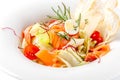 American cuisine concept. Caesar salad with salmon. White plate on a white background. Image for a menu of restaurants