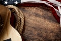 American culture, living on a ranch and country muisc concept theme with a cowboy hat, USA flag, rope lasso and acoustic guitar on