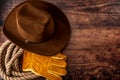 American culture, living on a ranch or farm and country muisc concept theme with a cowboy hat, rope lasso and rodeo leather gloves Royalty Free Stock Photo