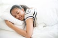 the American cute girl sleep with happy dream on white bed