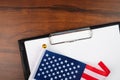 American document, mockup for text on clipboard, white sheet of paper in a folder for notes with usa flag Royalty Free Stock Photo