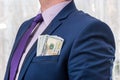 American dollar banknotes in businessman jacket`s pocket
