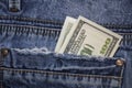 American 100 dollar bills in the back pocket of blue jeans Royalty Free Stock Photo