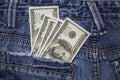 American 100 dollar bills in the back pocket of blue jeans Royalty Free Stock Photo