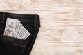 American dollar bills in jeans pocket on white wooden background with copy space for your text. Top view Royalty Free Stock Photo