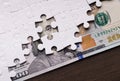 American dollar hidden under puzzle pieces