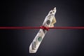 American dollar tied up in red rope knot on dark background with copy space. business finances, savings and bankruptcy concept Royalty Free Stock Photo