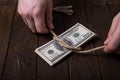 American dollar tied up in rope knot on dark background with copy space. business finances, savings and bankruptcy concept Royalty Free Stock Photo