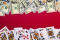 American dollars banknotes with playing cards on red background with copy space. Game addiction. Gambling, casino