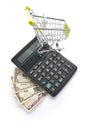 American dollars, calculator and grocery cart.