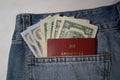 American dollars and foreign passport in the jeans pocket on the white background. Royalty Free Stock Photo