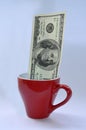 100 American dollars in a red cup Royalty Free Stock Photo