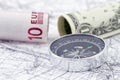 American and European currencies with compass