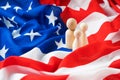 American family concept with wooden figurines of people standing on the flag of America. Royalty Free Stock Photo