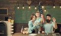 American family at desk with son making paper planes. Homeschooling concept. Kid with parents in classroom with usa flag Royalty Free Stock Photo