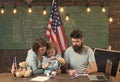 American family at desk with son making paper planes. Homeschooling concept. Parents teaching son to create, handmade Royalty Free Stock Photo