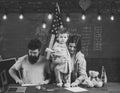 American family at desk with son making paper planes. Kid with parents in classroom with usa flag, chalkboard on Royalty Free Stock Photo