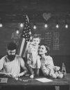 American family at desk with son making paper planes. Parents teaching son american traditions playing. Kid with parents Royalty Free Stock Photo