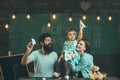 American family at desk with son play with paper planes. Homeschooling concept. Kid with parents in classroom with usa Royalty Free Stock Photo