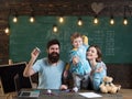 American family at desk with son play with paper planes. Kid with parents in classroom with usa flag, chalkboard on Royalty Free Stock Photo