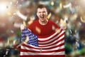 An American fan, a fan of a man holding the US national flag in his hands. Soccer fan in the stadium. Mixed media Royalty Free Stock Photo