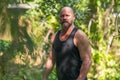 American farmer in a black tank top shirt posing outdoors