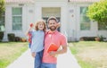 American father and son walking trough school park. Portrait of teacher and happy pupil. Royalty Free Stock Photo