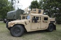 American fighting military vehicle among the trees with dark clouds