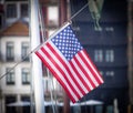 American Flag Against City Background Royalty Free Stock Photo