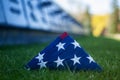 American flag on the background of grass and slab of the dead. Concept for Memorial Day and other holidays of the United Royalty Free Stock Photo