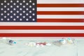 American flag on the background of pills and a syringe on the table. USA flag and medical supplies