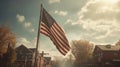 American flag blowing in the wind. In the background is a typical American town. Royalty Free Stock Photo