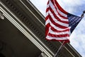 American Flag Blowing in the Wind in Front of Granite Building