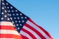 American flag in a blue sky, close up. Symbol of Independence Day fourth of July in USA