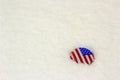 American flag bottle cap in the snow Royalty Free Stock Photo