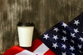 American flag and coffee paper cup on a old wooden background Royalty Free Stock Photo